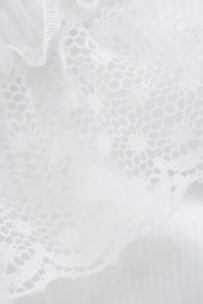 Close up of lace on babygro
