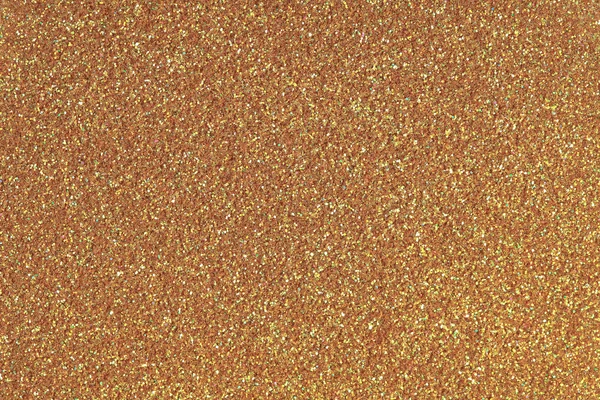 Golden glitter texture. Low contrast photo.
