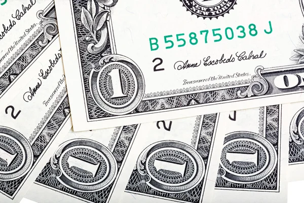 A background with american one dollar bills. Close-up photo.