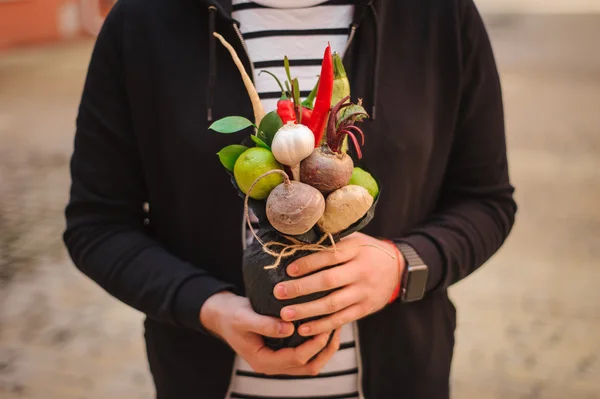 The original unusual edible vegetable and fruit bouquet  in man hands