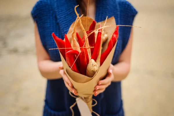 The original unusual edible vegetable and fruit bouquet in woman hands