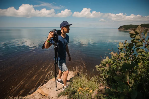 Man photographer holding his camera.