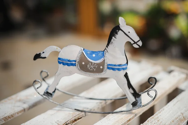 Antique rocking horse toy in white and blue