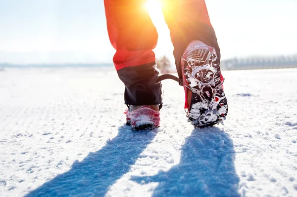 View of walking on snow with Snow shoes and Shoe spikes in winte