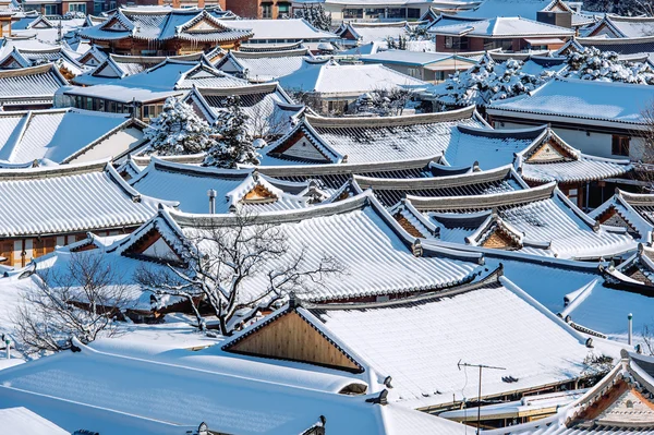 Roof of Jeonju traditional Korean village covered with snow, Jeonju Hanok village in winter, South Korea.