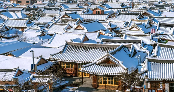 Roof of Jeonju traditional Korean village covered with snow, Jeonju Hanok village in winter, South Korea.