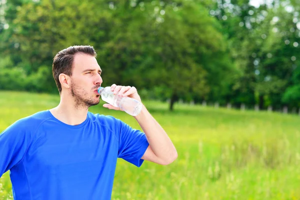 Man drinking water from bottle