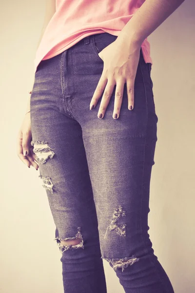 Female wearing jeans, vintage tone background