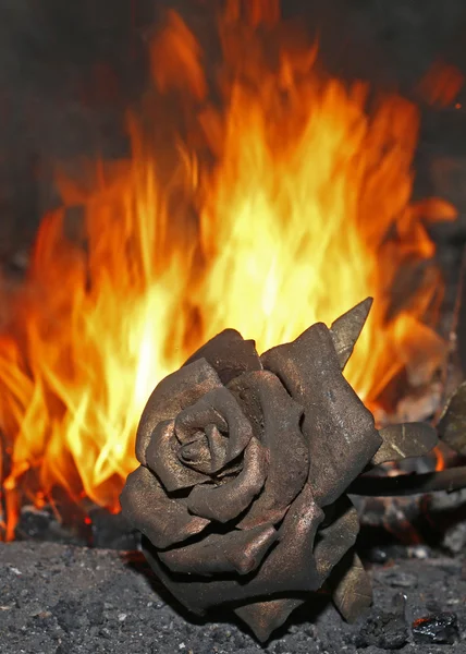 Forged rose on a background of fire