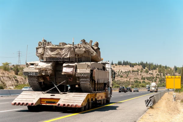 Tank Merkava carrier truck on the highway during the war in Israel