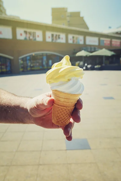 Ice cream in a man\'s hand.