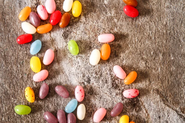 Colorful Jelly Beans on background stone