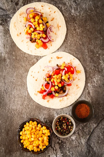 Mexican food - tacos with meat, corn and homemade salsa. on wood