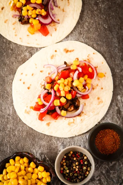 Mexican food - tacos with meat, corn and homemade salsa. on wood