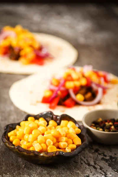 Mexican food - tacos with meat, corn and homemade salsa. on wood