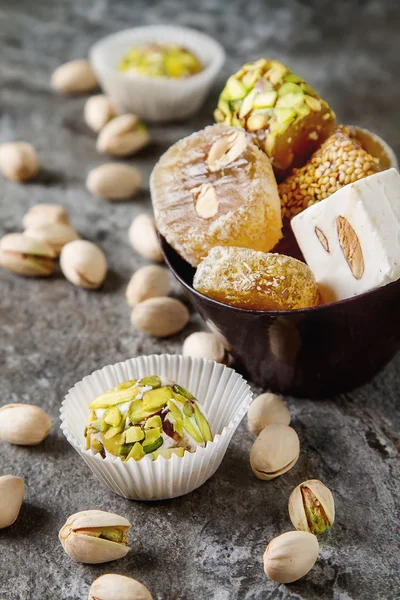 Eastern sweets. Turkish delight with pistachios in a vase. Dark