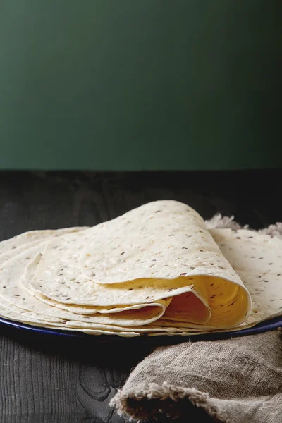 Tartilla sheets on a gray background. Brown cloth. Mexican food.