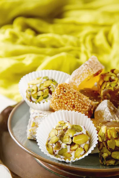 Eastern sweets. Turkish delight with pistachios in a vase. The f