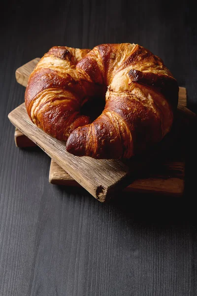 French food for breakfast. Fresh baked croissants. Dark wood bac