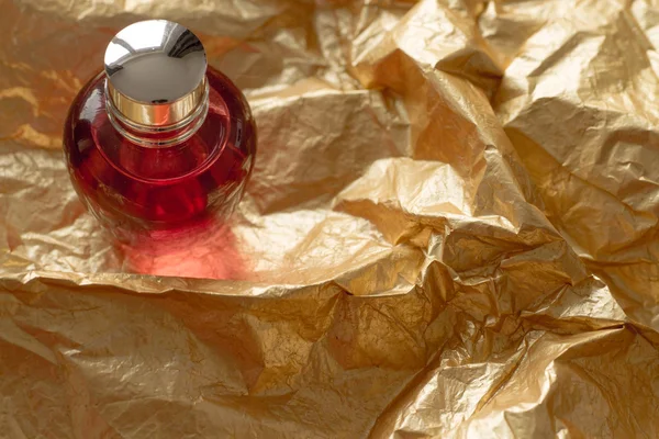 Gold paper perfume red bottle