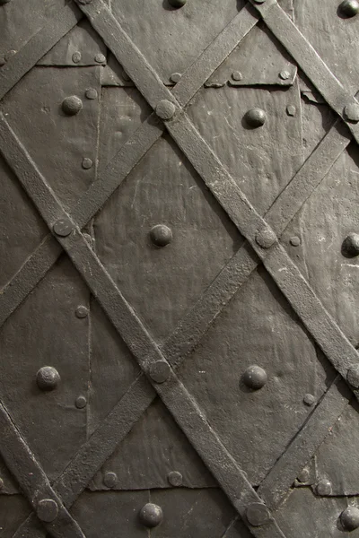 Black wrought door in medieval castle