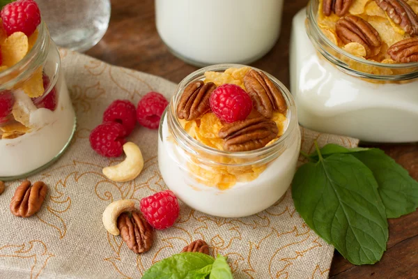 Yogurt for breakfast with nuts, raspberry and milk.