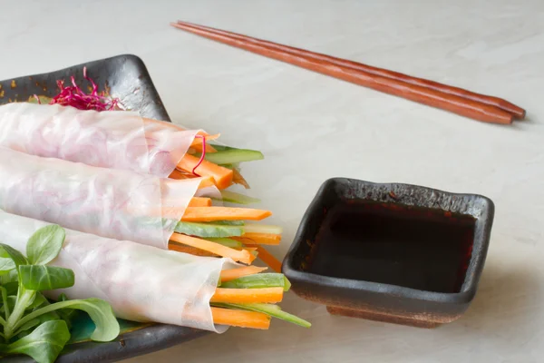 Spring roll of carrot and cucumber with soy sauce