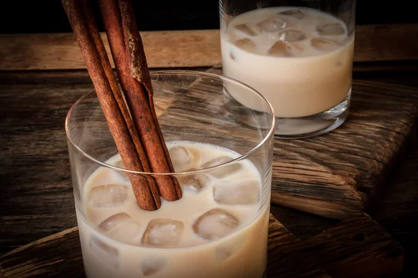 Irish cream liqueur in a glass with ice and cinnamon