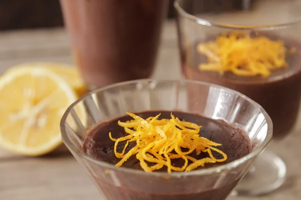 Chocolate mousse with orange chips on a dark background