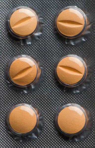 Orange pills in the pack closeup