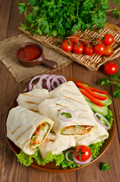Shawarma with meat and vegetables wrapped in pita bread