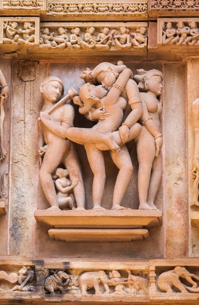 The sculpture made of sandstone, pair in the Kama Sutra pose.