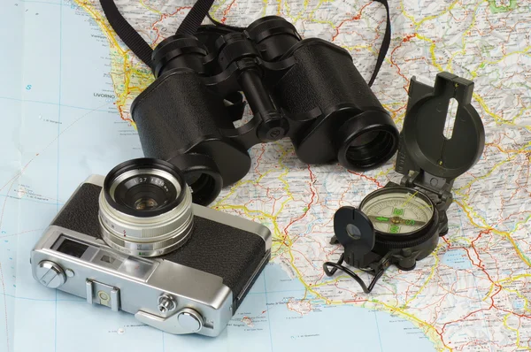 Binoculars, compass, camera and map