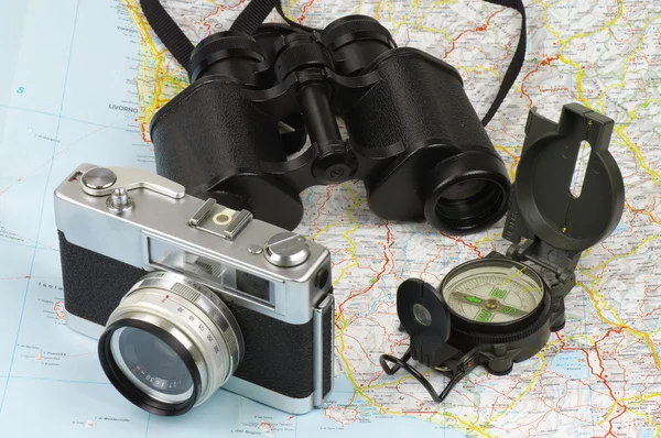 Binoculars, compass, camera and map