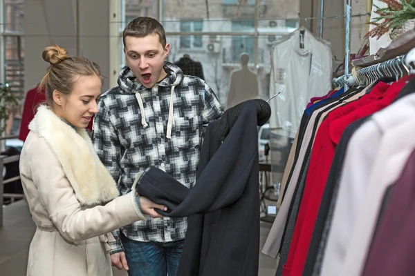 Young Couple in Clothing Shop Man excited