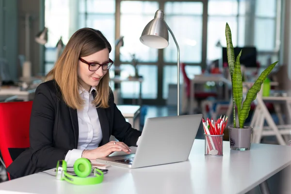 Beautiful Business Lady in official clothing working on Laptop