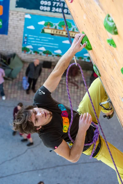 Climber trying to reach a hold on Climbing Wall