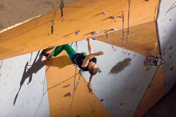 Climber trying to reach a hold on Climbing Wall