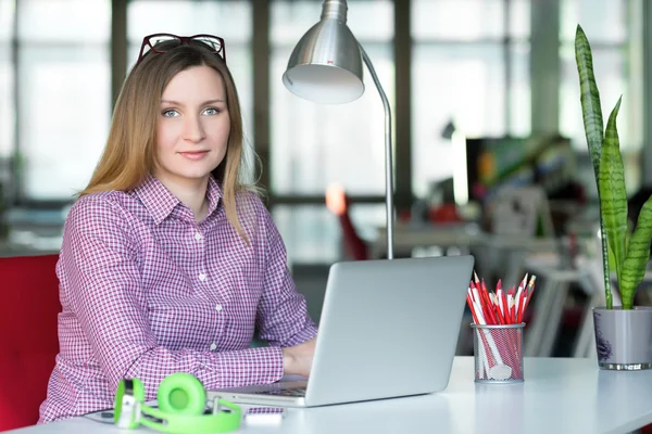 Charismatic Business Lady in casual clothing sitting at Office Table