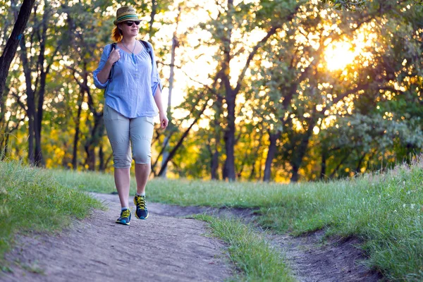 Female Hiker walking on Trail at Sunset