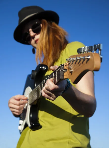Female street musician with guitar