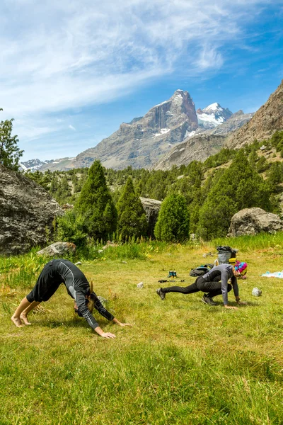 Young women doing morning fitness in mountain landscape
