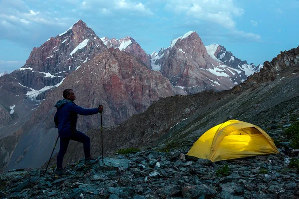 Hiker camping tent and mountain landscape