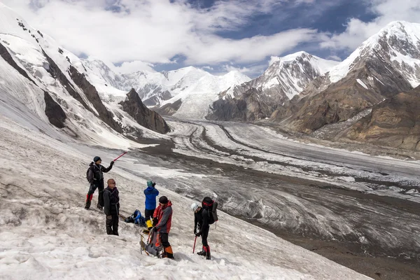 Group of Hikers Walking on Snow and Ice Terrain