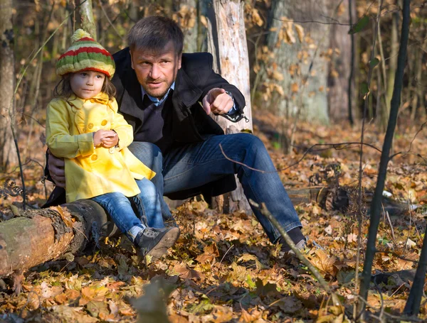 Father and Daughter Sitting in Forest and Watching Live Nature