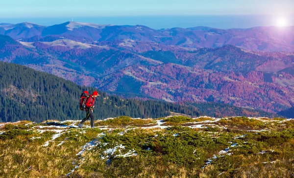 Hiker walking on Trail with Backpack Mountains View Sun Shining