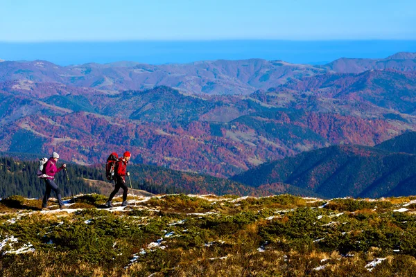 Simple Healthy Lifestyle Concept Image of Two Hikers walking in Mountains