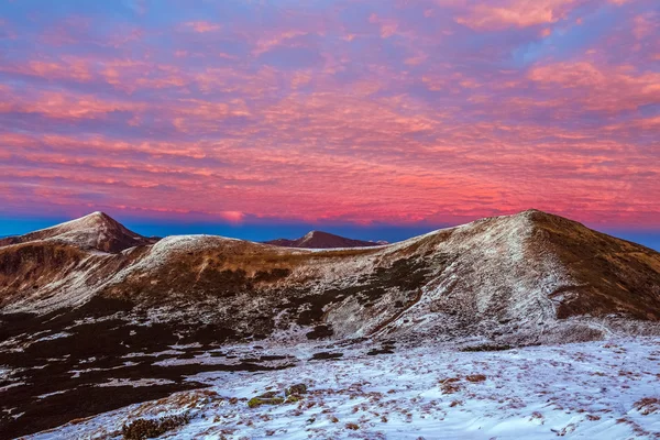 Unusual colors of Sunrise in Winter Mountains