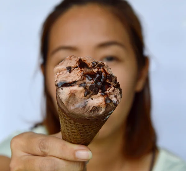 Chocolate ice cream in front of woman