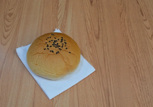Red bean filling bun on tissue paper